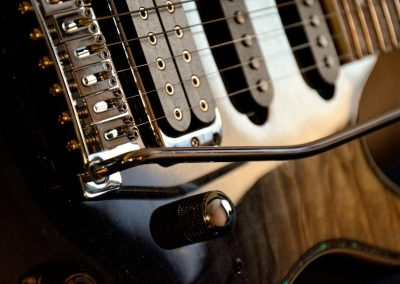 a close up of an electric guitar with a microphone