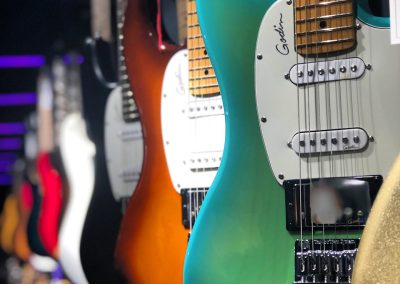 white and orange electric guitars